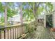 Back deck with weathered wood, lush greenery, and mature trees at 3403 Spring Harbour Drive Dr, Doraville, GA 30340