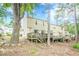 Back exterior view with multiple decks, natural setting, and mature trees at 3403 Spring Harbour Drive Dr, Doraville, GA 30340