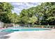 Community pool with clear blue water, lounge chairs, and lush landscaping at 3403 Spring Harbour Drive Dr, Doraville, GA 30340