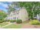 Charming two-story townhouse with light siding, brown shutters, and a well-manicured lawn at 3403 Spring Harbour Drive Dr, Doraville, GA 30340