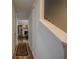 Inviting hallway with wood floors leads to a cozy living area featuring a fireplace and staircase at 3403 Spring Harbour Drive Dr, Doraville, GA 30340
