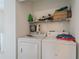 Convenient laundry room with washer, dryer, and shelving for storage and organization at 3403 Spring Harbour Drive Dr, Doraville, GA 30340