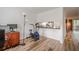 Bright living room featuring wood floors, an exercise bike, and view into a kitchen at 3403 Spring Harbour Drive Dr, Doraville, GA 30340