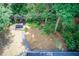 Lush backyard featuring mature trees, gravel pathways, and a wooden picnic table at 3531 Evans Ridge Dr, Atlanta, GA 30341