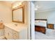 A bright bathroom with a vanity, mirror, and doorway view to the adjacent bedroom at 3531 Evans Ridge Dr, Atlanta, GA 30341