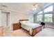 Cozy bedroom featuring natural light, neutral walls, ceiling fan, and wood furniture at 3531 Evans Ridge Dr, Atlanta, GA 30341