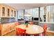Open-concept dining area featuring a round table, hardwood floors, and built-in cabinets with granite countertops at 3531 Evans Ridge Dr, Atlanta, GA 30341