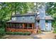 Charming two-story home with a covered porch and a peaceful, tree-filled setting, creating a serene environment at 3531 Evans Ridge Dr, Atlanta, GA 30341