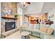 Open-concept living room features a stone fireplace, a cozy sectional sofa, and views into the dining area at 3531 Evans Ridge Dr, Atlanta, GA 30341
