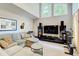 Spacious living room with high ceilings, large windows, sectional sofa, and entertainment center at 3531 Evans Ridge Dr, Atlanta, GA 30341