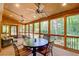 Inviting screened porch features a wood ceiling with fans and wooded view, perfect for relaxation and entertaining at 3531 Evans Ridge Dr, Atlanta, GA 30341