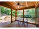 Cozy screened porch with wood flooring and forest views, offering a tranquil outdoor space for relaxation and contemplation at 3531 Evans Ridge Dr, Atlanta, GA 30341