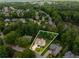 An aerial view shows a beautiful two-story home with a manicured lawn surrounded by mature trees in an established neighborhood at 6211 Traymore Se Trce, Smyrna, GA 30082