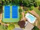 Aerial view displays two tennis courts and a pool with lounge chairs surrounded by mature landscaping and shady trees at 6211 Traymore Se Trce, Smyrna, GA 30082