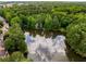 Scenic aerial view featuring a lush canopy of trees and a serene pond at 6211 Traymore Se Trce, Smyrna, GA 30082