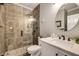 Modern bathroom featuring tiled shower with glass door and white vanity with undermount sink at 6211 Traymore Se Trce, Smyrna, GA 30082
