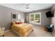 Bedroom featuring modern ceiling fan, tv, and sunny window views at 6211 Traymore Se Trce, Smyrna, GA 30082