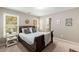 Bright bedroom with a dark wood sleigh bed, windows, and charming decorative accents at 6211 Traymore Se Trce, Smyrna, GA 30082
