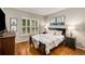 Cozy bedroom with plantation shutters, hardwood floors and nautical themed artwork at 6211 Traymore Se Trce, Smyrna, GA 30082
