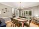 Charming dining space with a wooden table, modern lighting, and natural light from shuttered windows at 6211 Traymore Se Trce, Smyrna, GA 30082
