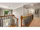 Upstairs hallway featuring black metal handrails and newel posts with wood caps at 6211 Traymore Se Trce, Smyrna, GA 30082