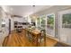 Bright kitchen with white cabinets, stainless steel appliances, a dining table, and large windows at 6211 Traymore Se Trce, Smyrna, GA 30082