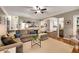 Open-concept living room with hardwood floors, a large sofa, and views into the kitchen at 6211 Traymore Se Trce, Smyrna, GA 30082