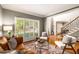 Inviting living area with hardwood floors, plantation shutters, and a staircase in view at 6211 Traymore Se Trce, Smyrna, GA 30082