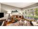 Comfortable living room featuring hardwood floors, plantation shutters, and stylish furnishings at 6211 Traymore Se Trce, Smyrna, GA 30082