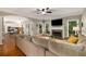 Spacious living room with hardwood floors, a fireplace, and views of the adjacent kitchen at 6211 Traymore Se Trce, Smyrna, GA 30082