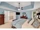 This main bedroom features a tray ceiling, ceiling fan, and ensuite bathroom at 6211 Traymore Se Trce, Smyrna, GA 30082