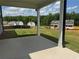 A new construction backyard with a concrete patio, lush green grass, and other new homes in the neighborhood at 777 Oakmont Trce, Canton, GA 30114
