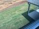 Backyard featuring newly laid sod, observed from a window with a partial view of a covered patio at 777 Oakmont Trce, Canton, GA 30114