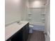 Well-lit bathroom boasts a dark brown vanity, a sleek white countertop, and a combined tub and shower with white surround at 777 Oakmont Trce, Canton, GA 30114