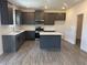 Well-lit kitchen features stainless steel appliances, a center island, and plentiful cabinet space at 777 Oakmont Trce, Canton, GA 30114