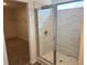 Modern bathroom featuring a glass enclosed shower with elegant marble tiling and a convenient walk-in closet at 777 Oakmont Trce, Canton, GA 30114