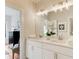 Bright bathroom with double sinks, modern lighting, and view to Primary bedroom at 1240 Oakland Sw Ter # B, Atlanta, GA 30310