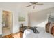 Comfortable bedroom with hardwood floors, ceiling fan, and adjacent bathroom featuring a glass shower at 1240 Oakland Sw Ter # B, Atlanta, GA 30310