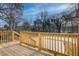 New wood deck overlooks lush greenery and the lake in the distance, promising serene outdoor enjoyment at 1240 Oakland Sw Ter # B, Atlanta, GA 30310