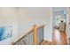 Upstairs hallway boasting hardwood floors and a staircase with wrought iron spindles at 1240 Oakland Sw Ter # B, Atlanta, GA 30310