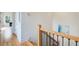 Hallway featuring hardwood floors and a staircase with wrought iron spindles at 1240 Oakland Sw Ter # B, Atlanta, GA 30310