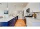 Modern kitchen featuring white countertops, navy blue cabinets, stainless steel appliances, and hardwood floors at 1240 Oakland Sw Ter # B, Atlanta, GA 30310