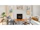 Cozy living room with fireplace, hardwood floors, neutral color palette, and access to the outdoor deck at 1240 Oakland Sw Ter # B, Atlanta, GA 30310