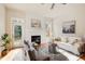 Bright living room featuring modern decor, a cozy fireplace, hardwood floors, and natural light from large windows at 1240 Oakland Sw Ter # B, Atlanta, GA 30310