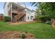 Inviting backyard with a wooden deck and stairs, a lush green lawn, and mature trees for shade and privacy at 130 White Sands Ct, Suwanee, GA 30024
