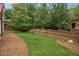 Beautifully landscaped backyard with lush green grass and privacy fence at 130 White Sands Ct, Suwanee, GA 30024