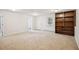 Spacious carpeted basement area with recessed lights, a built-in bookshelf, and a window at 130 White Sands Ct, Suwanee, GA 30024