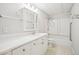 All white bathroom features a combo shower and tub, a large vanity with plentiful drawers at 130 White Sands Ct, Suwanee, GA 30024