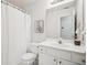 Clean bathroom with a shower/tub combo, featuring a single sink vanity and a mirrored wall at 130 White Sands Ct, Suwanee, GA 30024