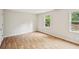 Bright, airy bedroom with hardwood floors and dual windows overlooking trees and landscape at 130 White Sands Ct, Suwanee, GA 30024